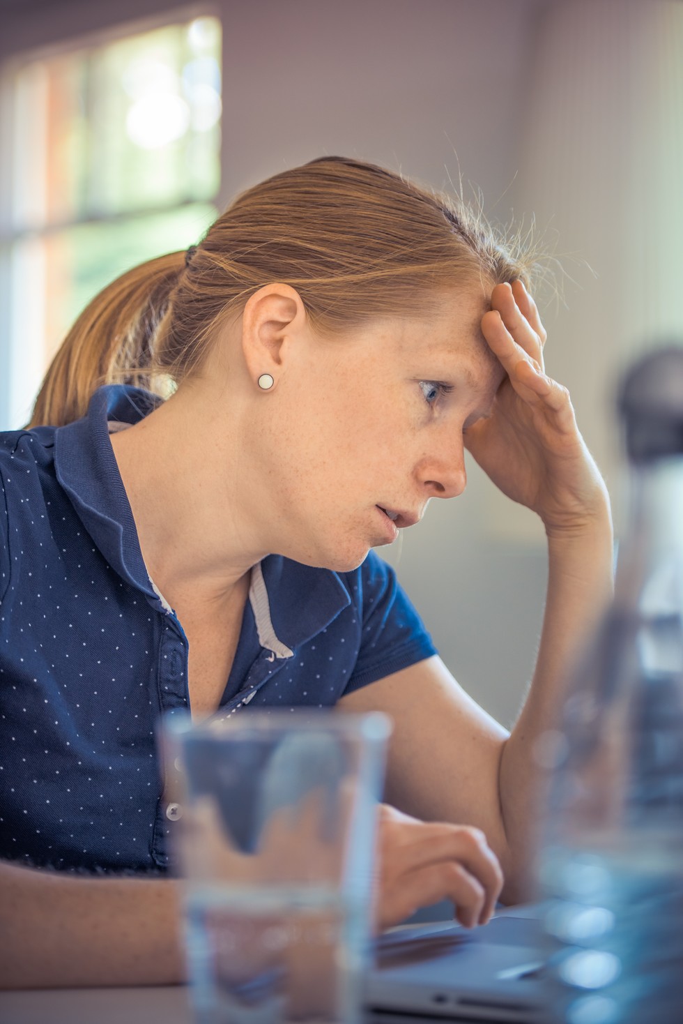 A woman stressed while on the computer