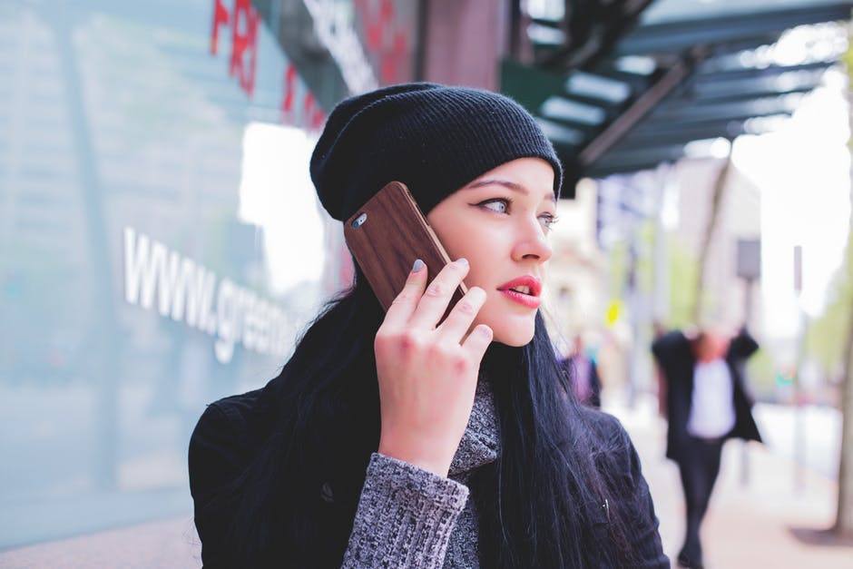 A woman on the phone on a busy street